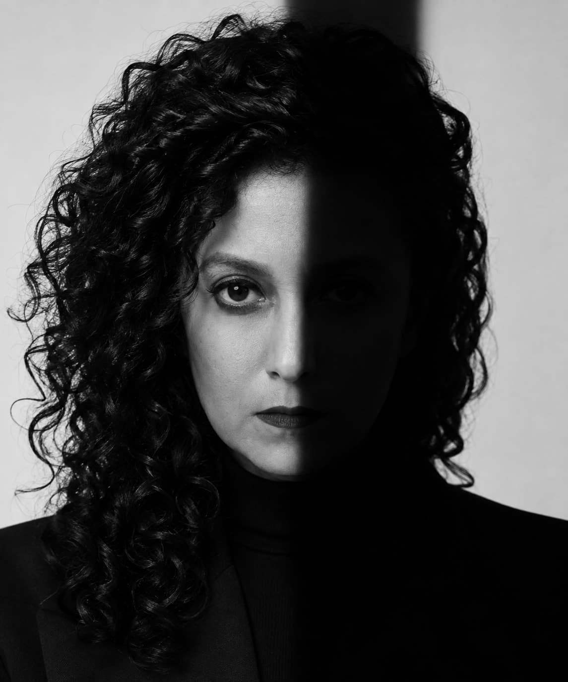 Florencia Lovera-Hampshire en blanco y negro, con el rostro dividido entre luz y sombra.